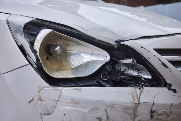 A damaged car with a broken headlight showcasing visible dents and scratches on its exterior highlights the importance of plastic bumper repair