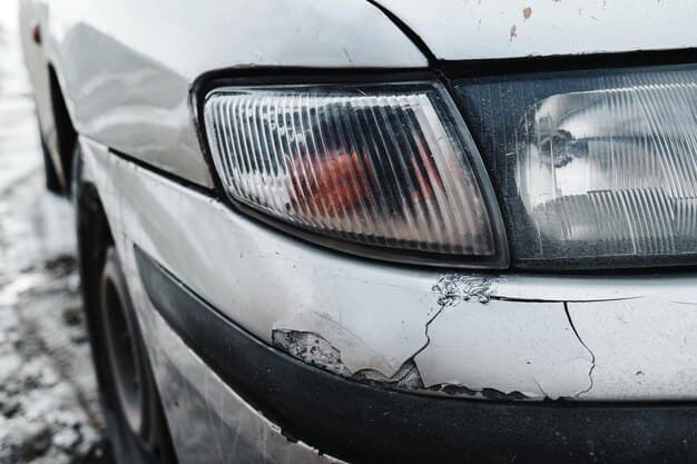 Close-up image of a car with visible damage and a broken headlight emphasizing the severity of the accident highlighting the importance of plastic bumper repair