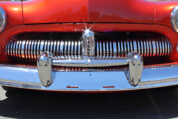 A close-up of the front end of a 1952 Mercury Cougar highlighting its vintage styling and iconic headlights ideal for those looking to restore chrome bumper