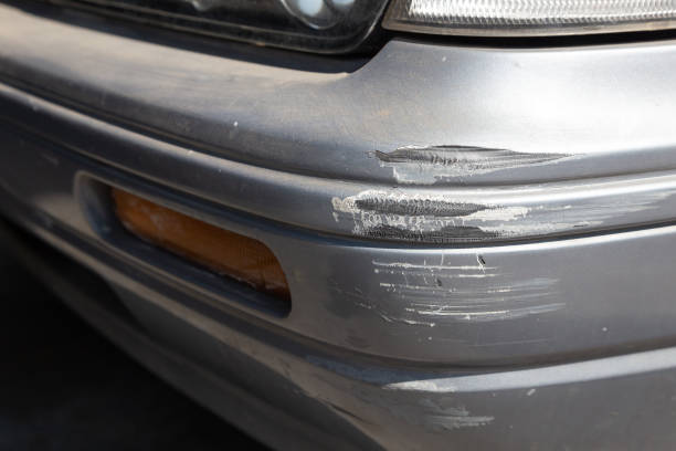 Close-up view of a car featuring a damaged bumper highlighting the extent of the impact and wear on the vehicle's exterior—protected by Chrome Bumper Repair Insurance Coverage