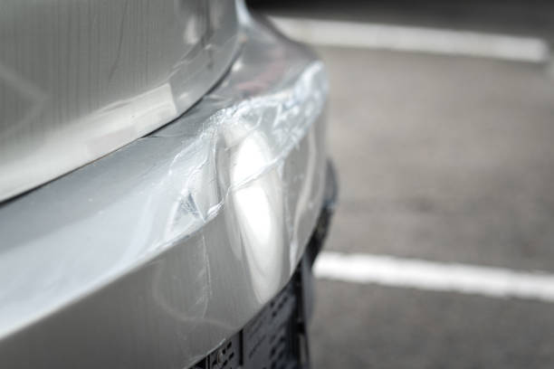 Close-up view of a car's bumper showing a noticeable dent highlighting damage to the vehicle's exterior—covered by Chrome Bumper Repair Insurance Coverage