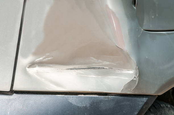 A damaged car featuring a noticeable dent on its side, emphasizing the need for professional services like replace bumper near me to restore its original condition