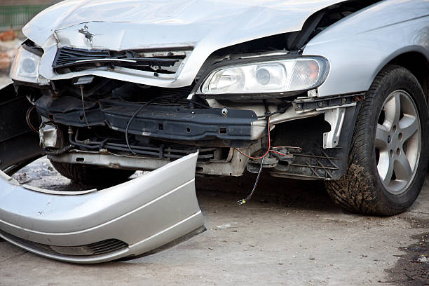 A car featuring a damaged front end characterized by a crushed bumper and misaligned hood highlighting the average bumper repair cost