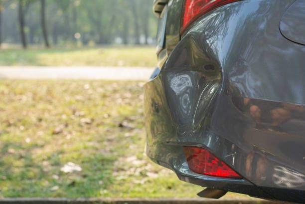 Detailed shot of a car's tail lights glowing red emphasizing the vehicle's modern design and safety features while exploring the average bumper repair cost