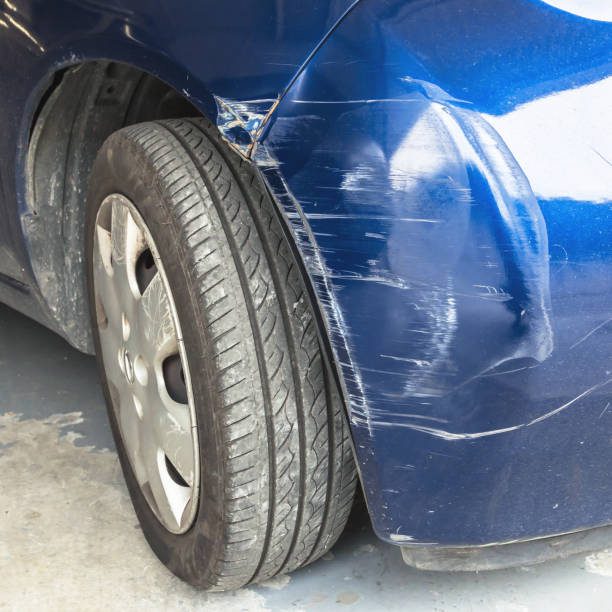 A blue vehicle displaying a damaged tire suggesting the necessity for immediate attention or maintenance just as one would prioritize estimating the bumper repair cost