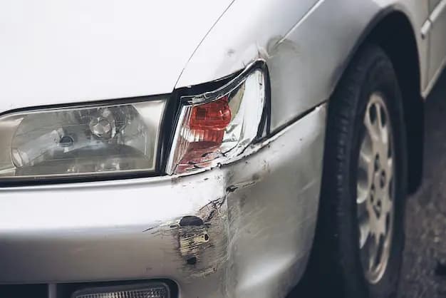 Close-up image of a car showing a broken bumper emphasizing the need to repair cracked bumper cover and highlighting the damage sustained to the vehicle's front end 