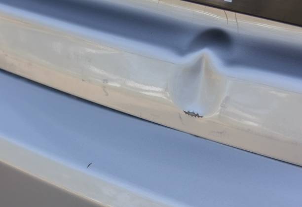 Close-up image of a car's front bumper showcasing how to put a bumper on a car by emphasizing the sleek design and intricate features of the vehicle