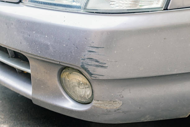 Close-up of a car with a visibly damaged bumper illustrating the effects of an accident and the need for small bumper crack repair on the vehicle's front end