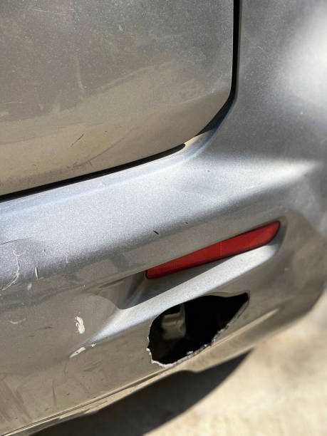 Close-up of a dented car bumper illustrating the damage and wear on the vehicle's surface requiring car bumper hole repair