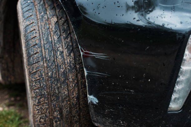 Detailed close-up of a car tire highlighting the tread design and a distinct tire mark left on the ground alongside the need for small bumper crack repair